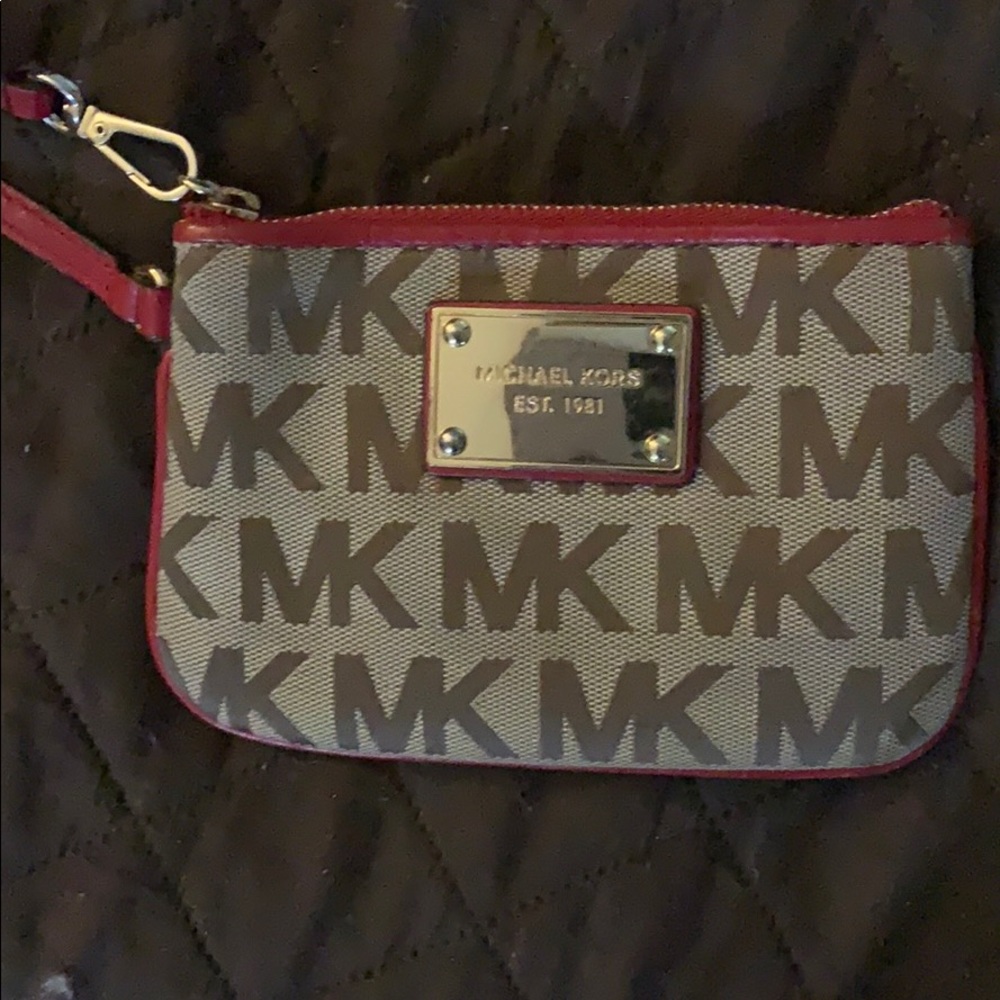 Small tan Michael kors wristlet with red trim
